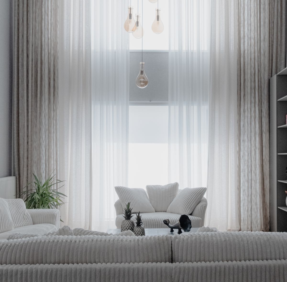 Soft white sofas and natural light in a calm modern living room